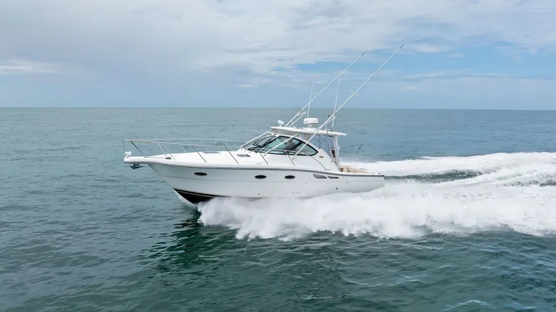 Slide: The Image of Dynamic Side View in Motion This image showcases the Tiara Yachts 32 Open, gracefully cutting through the waves. The sleek design of the hull and the elegant lines of the cabin are highlighted as the vessel speeds across the water, demonstrating its power and agility. The open sea s - 6394608