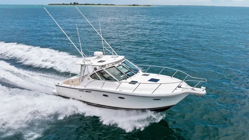 Slide: The Image of Tiara 32 Open Cruising View The 2007 Tiara 32 Open, named 'Second Chance', glides effortlessly across the water, showcasing its sleek hull and spacious cockpit. The boat's elegant profile is complemented by a robust bow railing and large windscreen, ensuring both safety and style. P - 6394610
