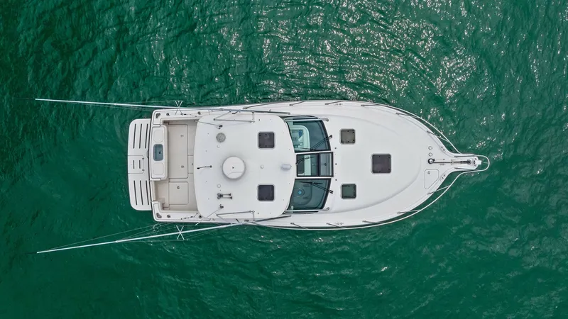 Slide: The Image of Aerial View of Tiara 32 Open This aerial shot showcases the sleek design of the 2007 Tiara 32 Open, highlighting its spacious cockpit and well-integrated swim platform. The vessel's clean lines and strategic hatch placements are visible, offering a glimpse of its functionality and el - 6394611
