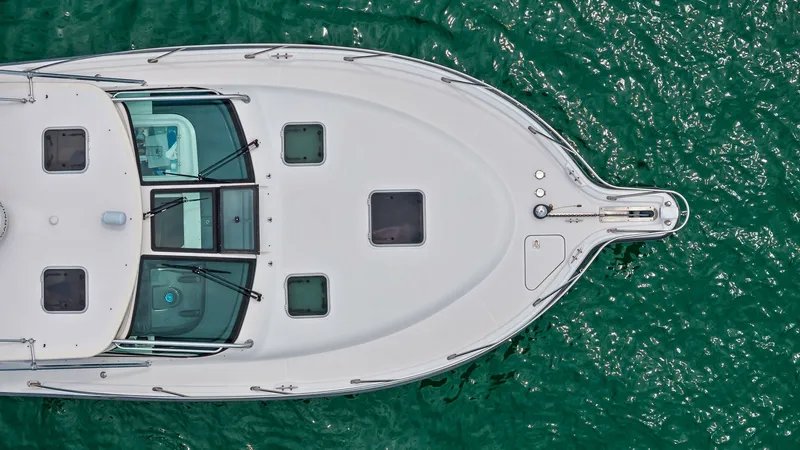 Slide: The Image of Aerial View of Bow Deck This image showcases the sleek bow deck of the 2007 Tiara Yachts 32 Open, 'Second Chance'. The deck is equipped with multiple hatches for ventilation and natural light, enhancing onboard comfort. The clean lines and robust construction reflect Tiara Yacht - 6394612