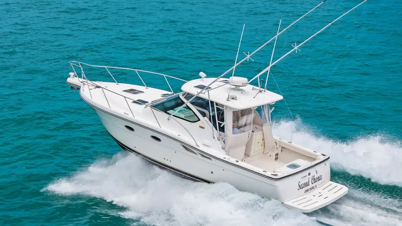 Slide: The Image of Aerial View of Tiara 32 Open This image showcases the Tiara 32 Open, highlighting its sleek design and robust build. The vessel is cruising effortlessly through the water, demonstrating its powerful performance and stability. Featuring a spacious aft deck ideal for fishing or leisure - 6394613