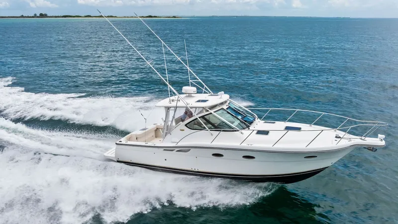 Slide: The Image of Tiara 32 Open Cruising at Speed This image showcases the Tiara 32 Open slicing through the water with ease, highlighting its sleek hull design and powerful performance. The spacious cockpit is visible, designed for comfort and functionality, perfect for fishing or leisure. The vessel's - 6394623