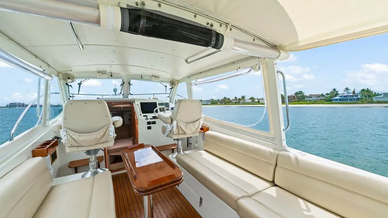 Slide: The Image of Spacious Cockpit with Helm View The cockpit of the 2008 MJM 29z Camelot offers a luxurious and inviting space with plush seating and polished wooden flooring. The helm station is equipped with modern navigation instruments, flanked by comfortable captain's chairs, ensuring a commanding - 6479392