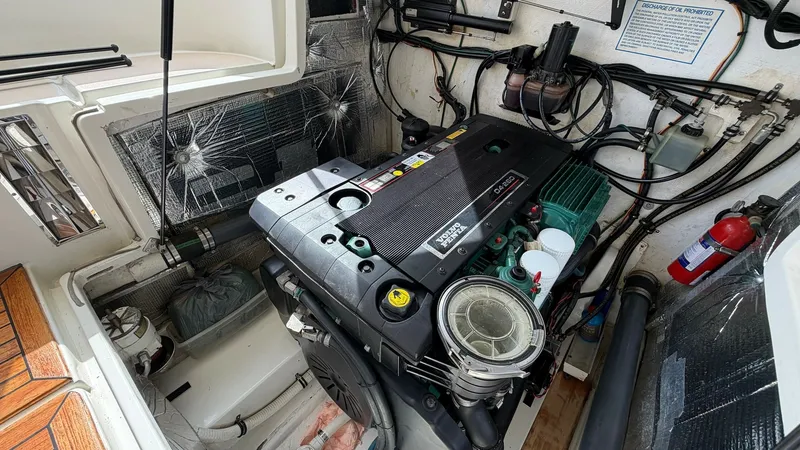 Slide: The Image of Engine Compartment with Volvo Penta Engine This image showcases the well-maintained engine compartment of the MJM Yachts 29z, featuring a robust Volvo Penta engine. The area is clean and organized, with insulated walls to reduce noise and vibration. Essential components, including the fire extingu - 6479427