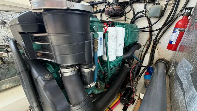 Slide: The Image of Engine Compartment with Volvo Penta Engine This image showcases the well-maintained engine compartment of the 2008 MJM Yachts 29z, featuring a robust Volvo Penta engine. The space is efficiently organized with accessible filters and a neatly routed exhaust system. Essential components are easily r - 6479432