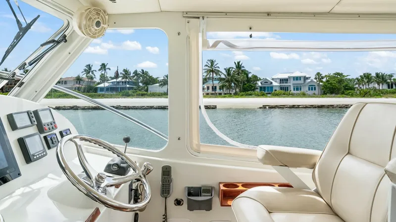 Slide: The Image of Helm Station with Panoramic View The helm station of the 2008 MJM Yachts 29z 'Camelot' features a sleek, modern design with a polished steering wheel and advanced control panels. The large windows offer a panoramic view, enhancing navigation and providing a scenic backdrop. Comfortable l - 6479387