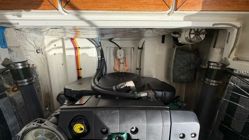 Slide: The Image of Engine Compartment with Volvo Penta This image showcases the well-maintained engine compartment of the 2008 MJM Yachts 29z, featuring a robust Volvo Penta engine. The space is neatly organized, with clearly labeled components and efficient cable management, ensuring easy access for maintena - 6479428