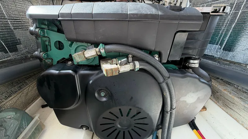 Slide: The Image of Engine Compartment View The image showcases the well-maintained engine compartment of the 2008 MJM Yachts 29z, Camelot. The powerful engine is neatly housed, emphasizing efficient use of space and accessibility for maintenance. The surrounding area features soundproofing materia - 6479431