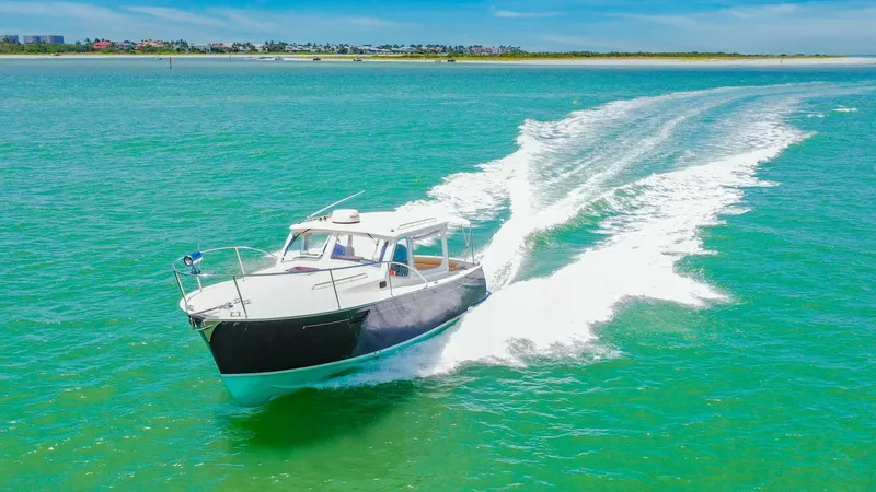 Slide: The Image of Aerial View of MJM 29z Cruising The 2008 MJM 29z Camelot cuts through the water with elegance, showcasing its sleek hull design and classic lines. The open cockpit and spacious deck provide ample room for leisure and enjoyment on the water. Its performance and style are evident, making - 6479440