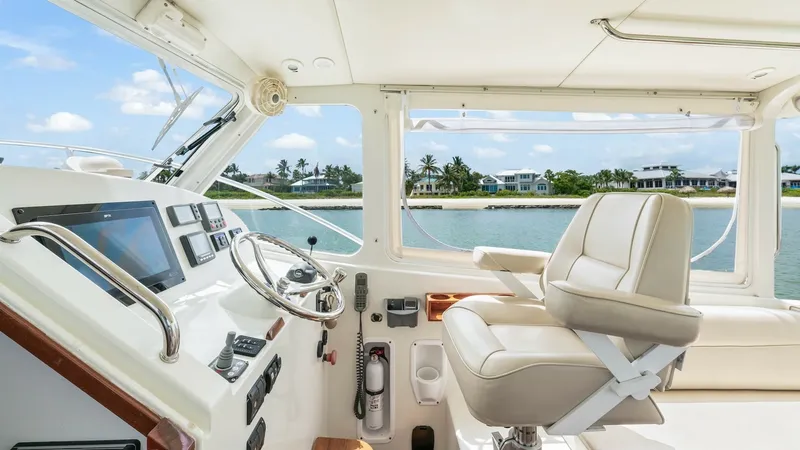 Slide: The Image of Helm Station with Panoramic View The helm station of the 2008 MJM Yachts 29z Camelot features a sleek, modern design with a comfortable captain's chair and state-of-the-art navigation equipment. Large windows provide a panoramic view, enhancing the boating experience with ample natural l - 6479388