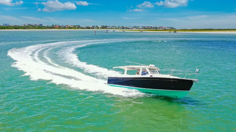 Slide: The Image of MJM 29z Cruising in Open Waters The 2008 MJM 29z 'Camelot' is captured gracefully gliding through pristine waters, showcasing its sleek hull design and effortless handling. With a vibrant blue hull and elegant lines, this vessel exudes both style and performance. The open cockpit offers - 6479436