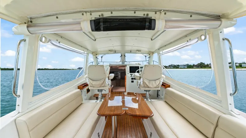 Slide: The Image of Spacious Cockpit with Helm Seating The cockpit of the 2008 MJM Yachts 29z offers a blend of comfort and functionality, featuring plush, cream-colored seating that lines both sides. The elegant wooden table at the center provides a perfect spot for dining or socializing. Forward, the helm a - 6479394