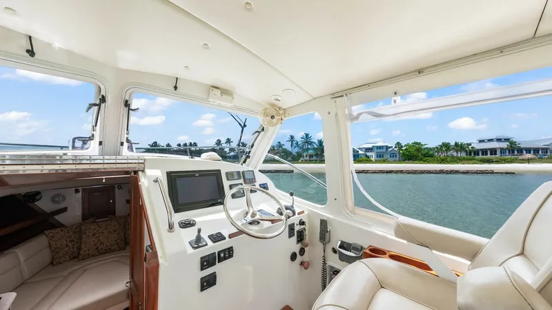 Slide: The Image of Helm Station with Panoramic Views The helm station of the 2008 MJM Yachts 29z Camelot offers a commanding view with its expansive windows, providing excellent visibility for navigation. The well-appointed area features a sleek steering wheel, modern instrumentation, and comfortable seatin - 6479384