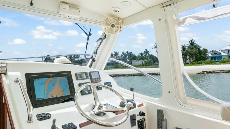 Slide: The Image of Helm Station with Navigation Displays The helm station of the 2008 MJM Yachts 29z features a sleek steering wheel and state-of-the-art navigation equipment, including a large display for easy route planning. The area is designed for optimal visibility and comfort, with large windows providing - 6479385