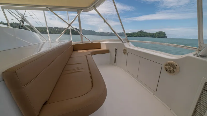Slide: The Image of Flybridge Seating 2002 Viking 61 Convertible Experience the expansive flybridge of the 2002 Viking 61 Convertible, featuring comfortable tan upholstered seating that offers panoramic ocean views. The area is sheltered by a sturdy frame, providing a perfect blend of openness and protection. Ideal for - 6683668