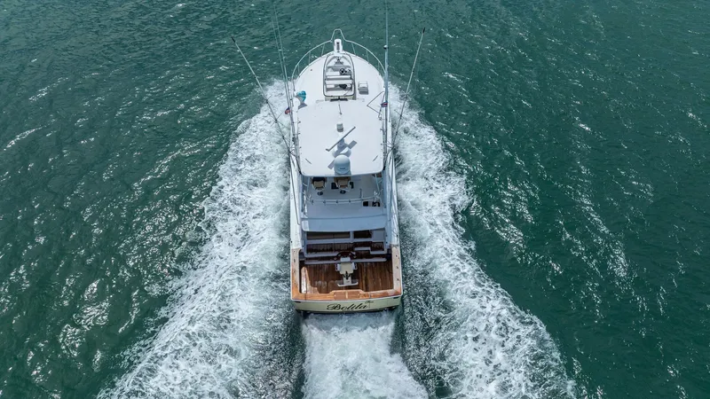 Slide: The Image of Aerial View of Stern in Motion 2002 Viking 61 Convertible This dynamic aerial shot captures the Viking 61 Convertible 'Bolita Too' from the stern as it cuts through the water. The spacious aft deck is equipped for fishing and entertainment, showcasing the vessel's versatility and performance. The powerful wake h - 6683695