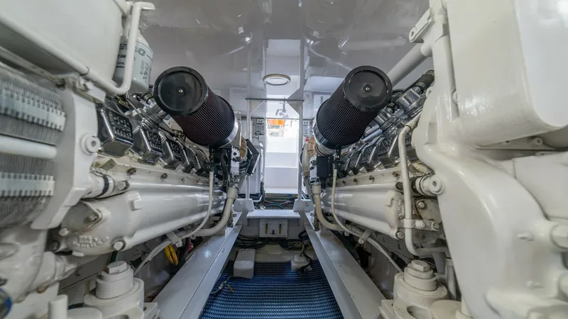 Slide: The Image of Engine Room with Twin Engines 2002 Viking 61 Convertible The engine room of the 2002 Viking 61 Convertible showcases twin powerful engines, meticulously maintained for peak performance. The space is well-organized, highlighting the yacht's commitment to functionality and reliability. Clean surfaces and strategi - 6683657
