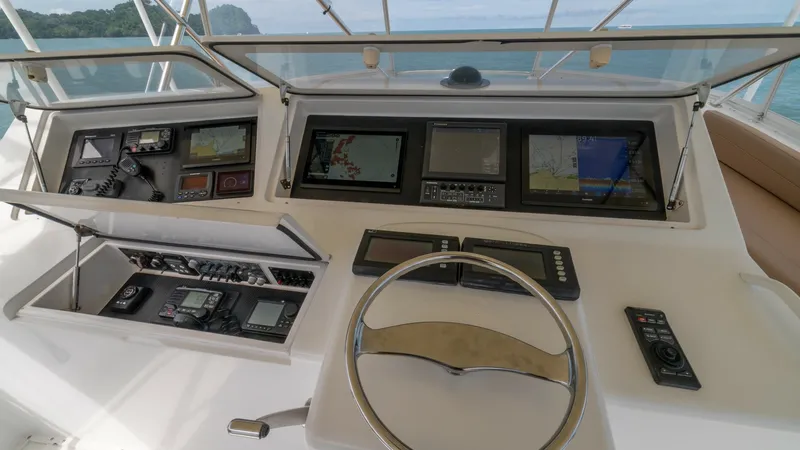 Slide: The Image of Helm Station with Electronics 2002 Viking 61 Convertible The helm station of the 2002 Viking 61 Convertible showcases a sophisticated array of electronics, including multiple navigation displays and control panels. The ergonomic layout ensures ease of operation, with a sleek, polished steering wheel centrally p - 6683663