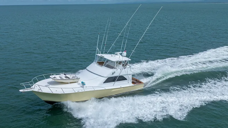 Slide: The Image of Aerial View of 2002 Viking 61 Convertible This dynamic aerial shot captures the Viking 61 Convertible slicing through the water with impressive speed and elegance. The vessel's sleek hull and expansive flybridge are prominently displayed, showcasing its robust design and excellent sea-handling ca - 6683694