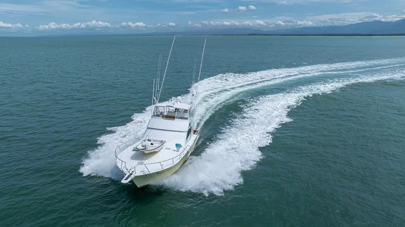 Slide: The Image of Aerial View of Bow in Motion The 2002 Viking 61 Convertible, Bolita Too, cuts through the water with impressive speed and elegance. This aerial shot showcases the sleek design and powerful performance of the vessel as it creates a dynamic wake. The spacious bow area and well-crafted - 6683683