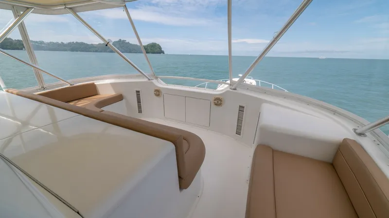 Slide: The Image of Flybridge Seating area 2002 Viking 61 Convertible This inviting flybridge on the 2002 Viking 61 Convertible, Bolita Too, offers spacious seating with cushioned benches, perfect for enjoying panoramic ocean views. The sleek white finish complements the tan upholstery, creating a stylish and comfortable en - 6683667