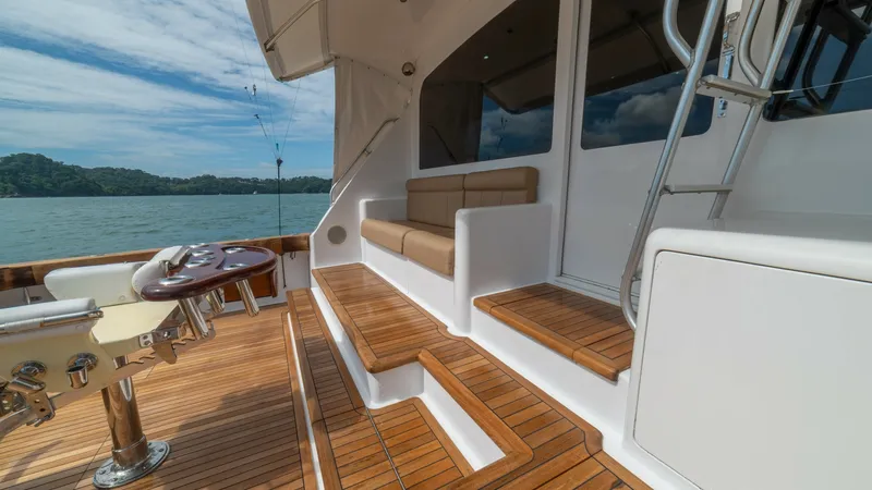 Slide: The Image of Teak Cockpit with Seating Area 2002 Viking 61 Convertible The cockpit of the 2002 Viking 61 Convertible features elegant teak decking, providing a warm and inviting ambiance. A comfortable seating area is tucked against the cabin, offering a perfect spot to relax and enjoy the view. The well-designed layout incl - 6683647