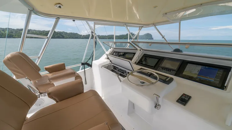 Slide: The Image of Flybridge Helm with Seating 2002 Viking 61 Convertible The flybridge helm of the 2002 Viking 61 Convertible features state-of-the-art navigation displays and a sleek, modern design. Two plush, adjustable captain's chairs provide comfort and excellent visibility over the expansive ocean views. The clean, ergon - 6683662