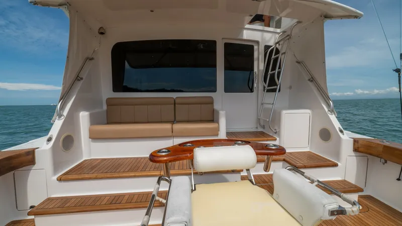 Slide: The Image of Cockpit with Seating 2002 Viking 61 Convertible The aft deck of the 2002 Viking 61 Convertible 'Bolita Too' features a well-appointed seating area with plush cushions, perfect for relaxation and socializing. The finely crafted teak flooring adds a touch of elegance, while the integrated fishing chair s - 6683650