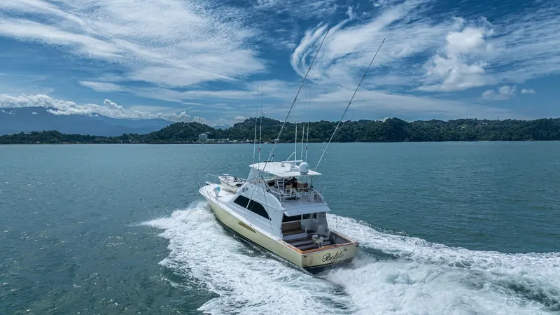 Slide: The Image of Aerial View of 2002 Viking 61 Convertible This stunning aerial shot captures the Viking 61 Convertible, showcasing its sleek lines and spacious aft deck. The vessel's powerful design is evident as it glides through the water, leaving a striking wake behind. The flybridge and open cockpit are perf - 6683697