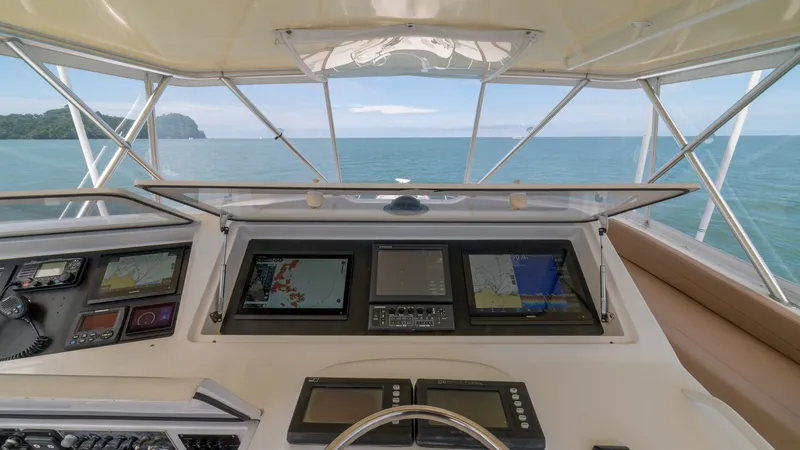 Slide: The Image of Flybridge Helm with Electronics 2002 Viking 61 Convertible The flybridge helm of the 2002 Viking 61 Convertible features a comprehensive electronics suite for optimal navigation. Multiple display screens provide critical information, ensuring precise control and safety. The open view enhances visibility, making i - 6683664