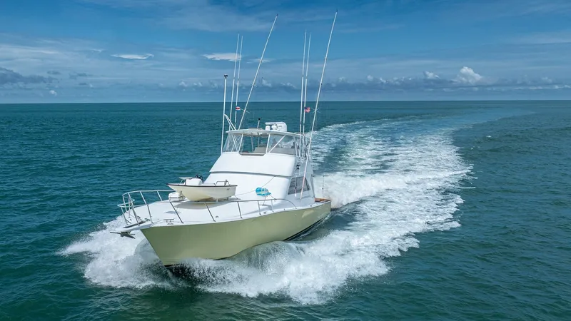 Slide: The Image of 2002 Viking 61 Convertible Bow in Motion The Viking 61 Convertible, Bolita Too, is captured elegantly slicing through calm waters, showcasing its powerful design and seaworthiness. The sleek bow, complemented by a robust stainless steel rail and spacious foredeck, emphasizes its capability for o - 6683696