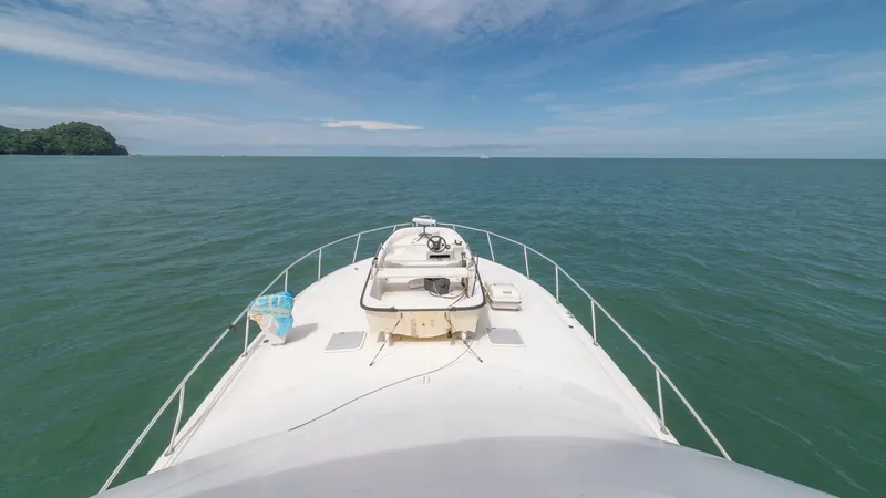 Slide: The Image of Bow View 2002 Viking 61 Convertible The bow of the 2002 Viking 61 Convertible, 'Bolita Too', offers a commanding view over the tranquil ocean waters. This spacious area is highlighted by a clean deck layout, perfect for lounging and enjoying the open sea. The sturdy railings and clear skies - 6683670