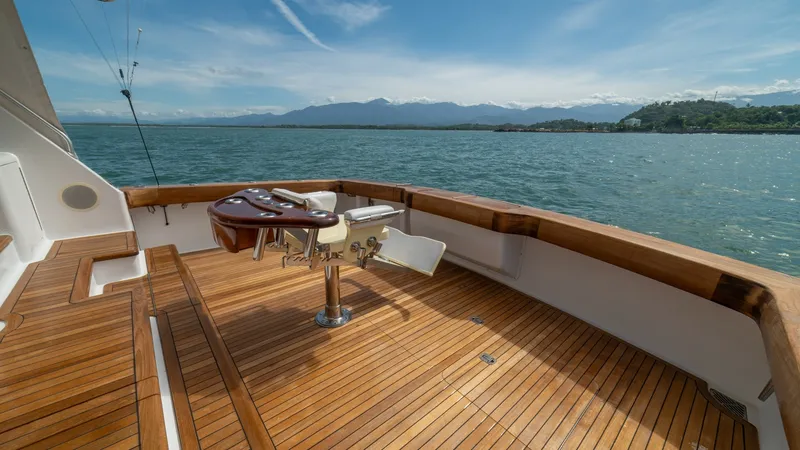 Slide: The Image of Spacious Teak Cockpit with Rod Holders 2002 Viking 61 Convertible This 2002 Viking 61 Convertible features a spacious cockpit with beautifully finished teak flooring, offering a perfect platform for fishing or relaxation. The central fighting chair is equipped with rod holders, catering to serious anglers. The surroundi - 6683646