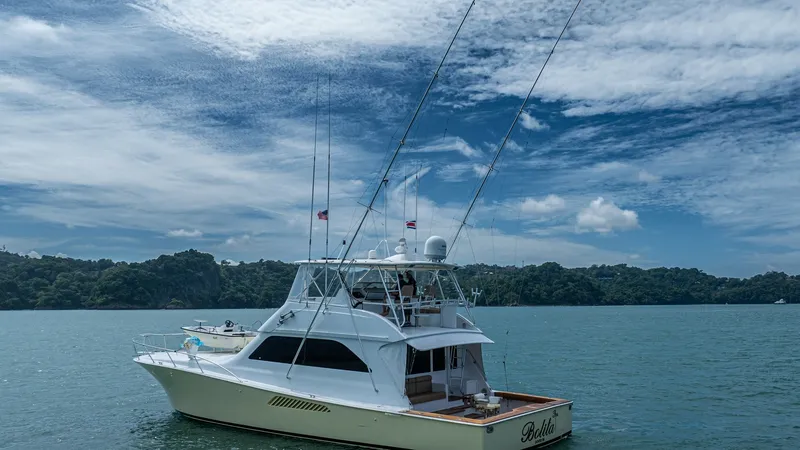 Slide: The Image of Aft Deck and Starboard View 2002 Viking 61 Convertible This image showcases the sleek design of the 2002 Viking 61 Convertible, 'Bolita Too,' from a starboard aft angle. The spacious aft deck is ideal for fishing or leisure, complemented by the vessel's streamlined profile and sportfishing capabilities. The e - 6683676