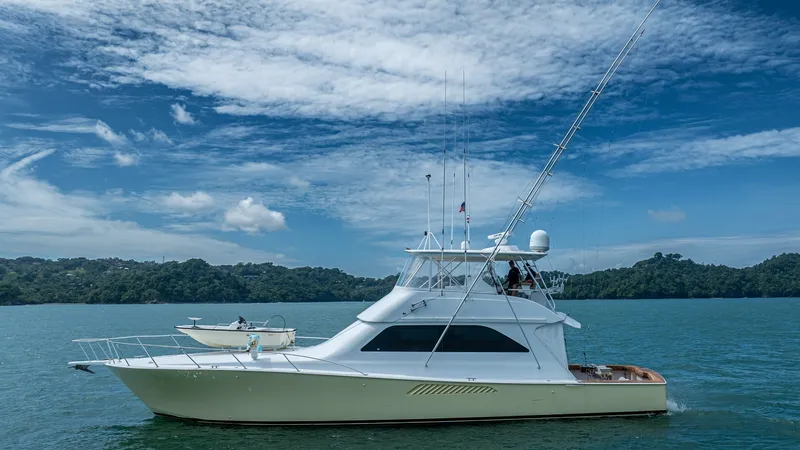 Slide: The Image of Starboard Profile of Viking 2002 Viking 61 Convertible This image showcases the sleek starboard profile of the 2002 Viking 61 Convertible, Bolita Too. The yacht features a graceful hull and a well-appointed flybridge, complete with antennas and outriggers for optimal offshore performance. The elegant lines an - 6683673