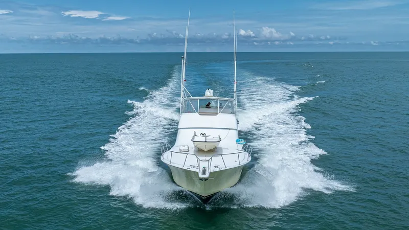 Slide: The Image of Bow View in Action 2002 Viking 61 Convertible The image captures the Viking 61 Convertible 'Bolita Too' from the front, showcasing its sleek hull cutting through the water with impressive power. The spacious foredeck is clearly visible, emphasizing the vessel's robust design and superior seakeeping a - 6683687