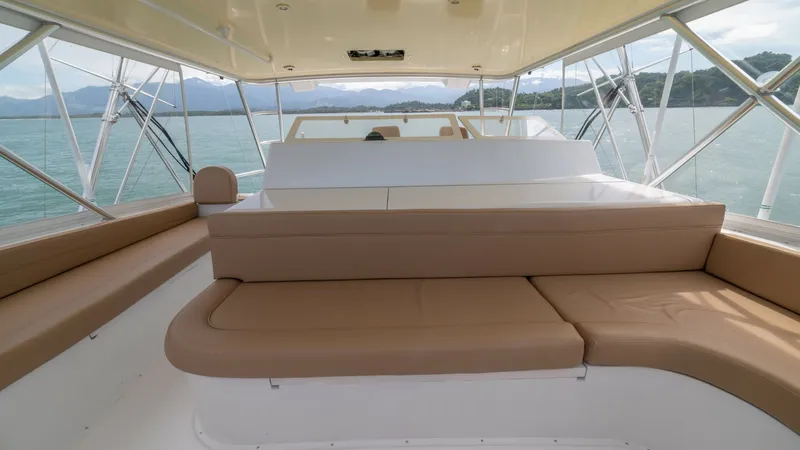 Slide: The Image of Flybridge Seating Area 2002 Viking 61 Convertible This spacious flybridge on the 2002 Viking 61 Convertible features comfortable tan upholstered seating with panoramic views. The open layout allows for easy movement and socializing, while the surrounding windows provide ample natural light and stunning v - 6683669