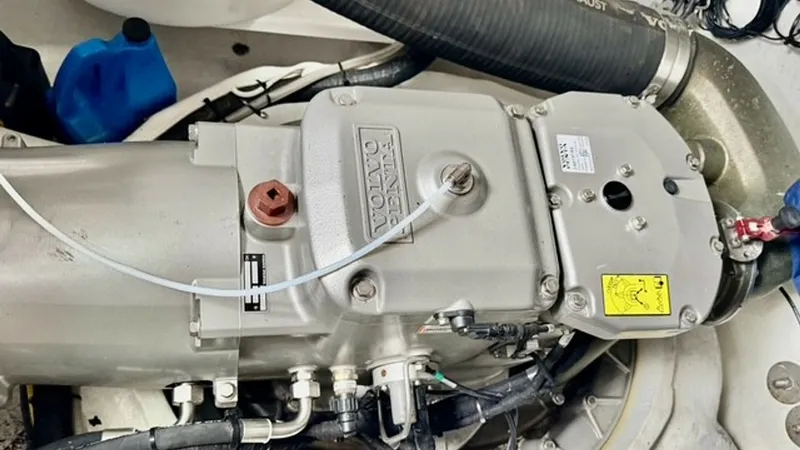 Slide: The Image of Engine Compartment with Volvo Penta This image showcases the engine compartment featuring a robust Volvo Penta engine, highlighting the high-performance machinery of the 2023 Cruisers Yachts 50 Cantius. The clean layout and organized wiring demonstrate meticulous engineering and easy access - 6489165