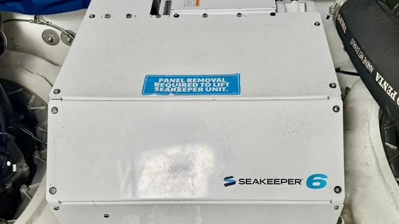 Slide: The Image of Engine Room with Seakeeper 6 Gyro The image showcases the Seakeeper 6 Gyro Stabilizer installed in the engine room of the 2023 Cruisers Yachts 50 Cantius. This advanced system significantly reduces boat roll, enhancing onboard comfort and stability. The clean installation and accessible p - 6489166