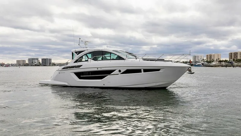 Slide: The Image of Side Profile of 2023 Cruisers 50 Cantius This image showcases the sleek, modern design of the 2023 Cruisers Yachts 50 Cantius. The yacht features a streamlined profile with expansive windows that provide ample natural light and stunning views. Its elegant hull design and contemporary lines make - 6489169