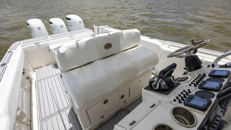 Slide: The Image of Helm and Seating Area This image showcases the helm and seating area of the 2005 Triton 351 Center Console. The helm is equipped with modern controls and displays, ensuring smooth navigation. The cushioned seating provides comfort for passengers, while the sleek deck design ad - 6687463