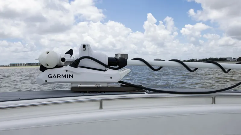 Slide: The Image of Bow with Garmin Radar Equipment The image showcases the bow of the 2005 Triton 351 Center Console, featuring advanced Garmin radar equipment. This high-tech system enhances navigation and safety, making it ideal for offshore excursions. The sleek design complements the vessel's modern a - 6687477