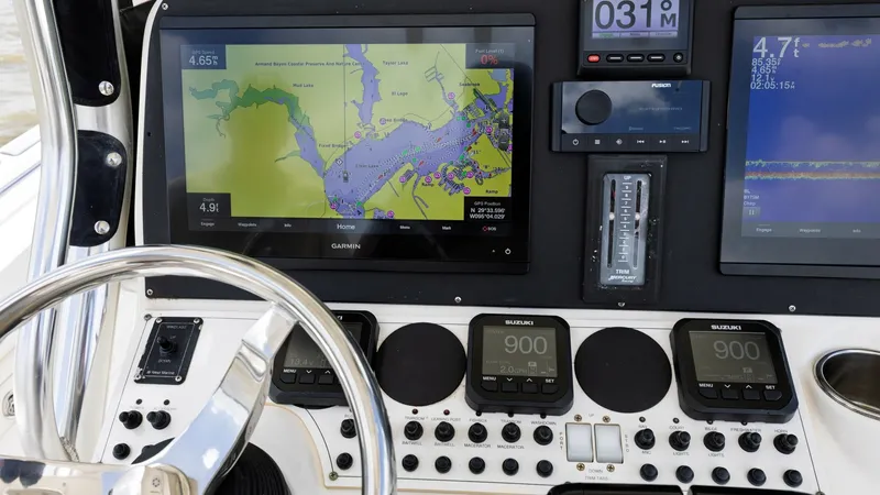 Slide: The Image of Helm Station with Navigation Screens The helm station of the 2005 Triton 351 Center Console features state-of-the-art navigation technology. Prominent displays provide detailed chart plotting and vital navigational data, ensuring a smooth and informed journey. The sleek design of the control - 6687460