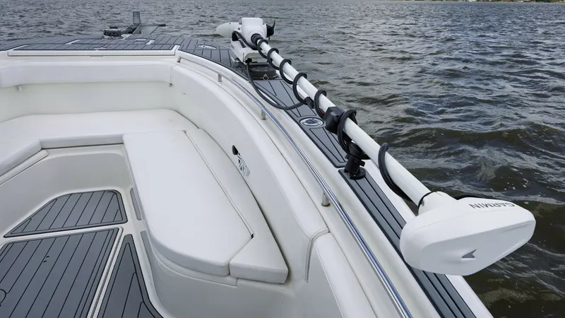 Slide: The Image of Bow Seating with Trolling Motor The 2005 Triton 351 Center Console features a spacious bow area equipped with comfortable seating and a sleek trolling motor setup. The cushioned bench provides ample relaxation space, while the advanced motor ensures precision and control during fishing - 6687475