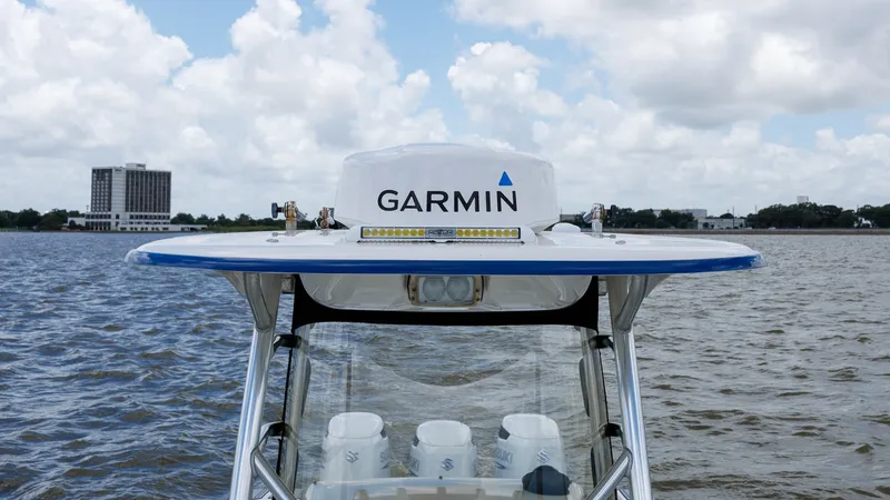 Slide: The Image of Center Console T-Top with Electronics This image showcases the T-top of the 2005 Triton 351 Center Console, equipped with advanced Garmin electronics. The sturdy T-top provides shade and protection, while the integrated lighting enhances visibility. The sleek design complements the vessel's s - 6687462