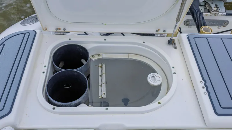 Slide: The Image of Cockpit Livewell and Storage Compartment This image showcases the Triton 351 Center Console's cockpit with a dual livewell and storage compartment, ideal for keeping bait fresh during fishing trips. The well-designed space includes easy-access lids and integrated cup holders, ensuring convenienc - 6687473