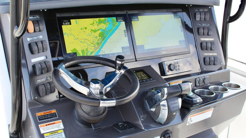 Slide: The Image of Helm Station with Dual Displays The helm station of the 2020 Blackfin 332 Center Console features a sleek, modern design with dual high-resolution displays for navigation and system monitoring. The ergonomic steering wheel and intuitive control layout ensure ease of operation while out - 6687433