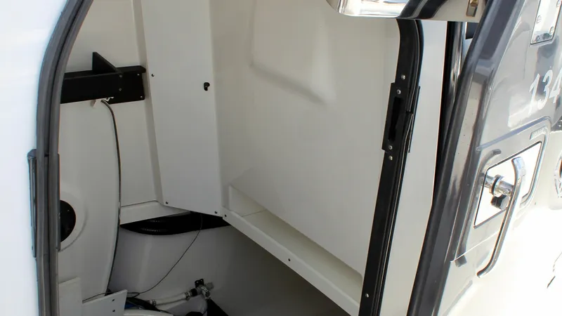 Slide: The Image of Interior Storage Compartment This image showcases the interior storage compartment of the Blackfin 332 Center Console. The space is designed for functionality, offering ample room for storing essential gear and equipment. The clean, white finish and organized layout enhance accessibi - 6687447