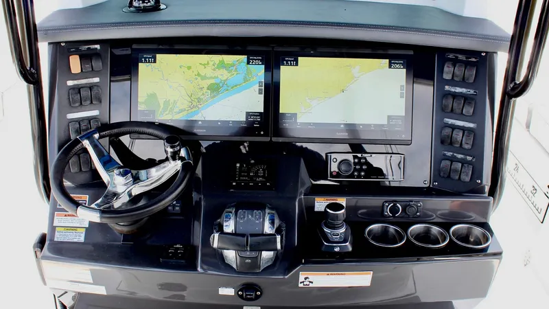 Slide: The Image of Helm Station with Dual Displays The helm station of the 2020 Blackfin 332 Center Console features dual high-resolution displays for comprehensive navigation and monitoring. The sleek, modern console is equipped with a polished steering wheel and an array of accessible controls, ensuring - 6687437