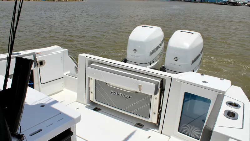 Slide: The Image of Aft Deck with Dual Engines The aft deck of the 2020 Blackfin 332 Center Console features dual Mercury engines, providing robust power for offshore adventures. The spacious deck area offers practical storage solutions and easy access to fishing amenities, making it ideal for anglers - 6687441